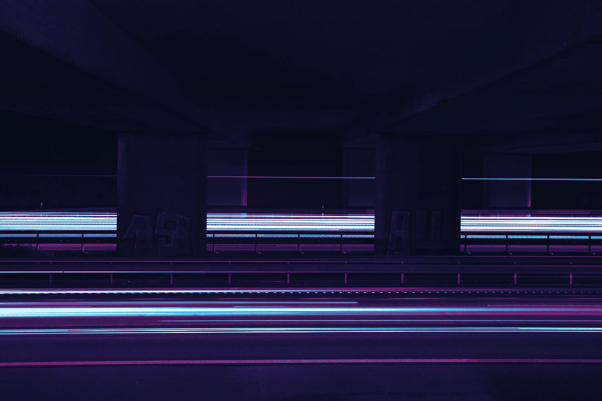 Three vertical bands of cyan light, blurred as if spinning