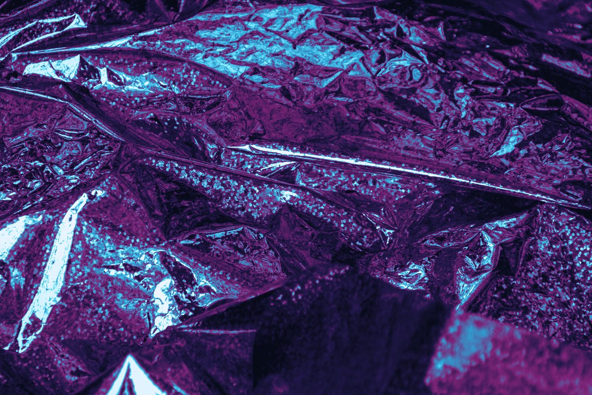 A dark panel with magenta light showing through scraped lines