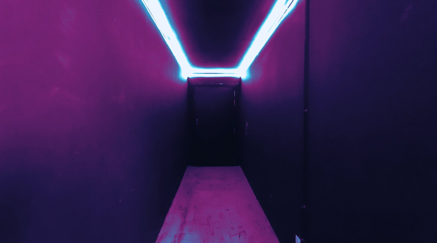 Cyan and magenta light trails crossing a dark cobalt grid